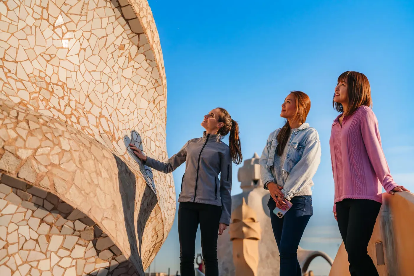 Visitors examine a curved architectural detail at La Pedrera.